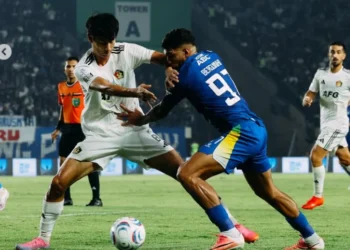 Pemain berseragam biru nomor 97 berebut bola dengan pemain berseragam putih dalam pertandingan Persib melawan Persik