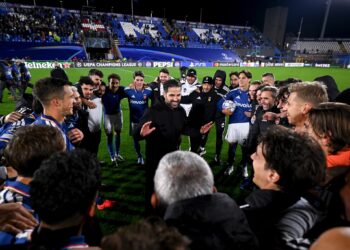Cesc Fabregas berbicara kepada para pemain Como 1907 yang berkumpul di lapangan sepak bola.