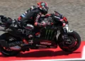 Marco Bezzecchi mengendarai motor Aprilia berwarna hitam dengan aksen merah di lintasan balap